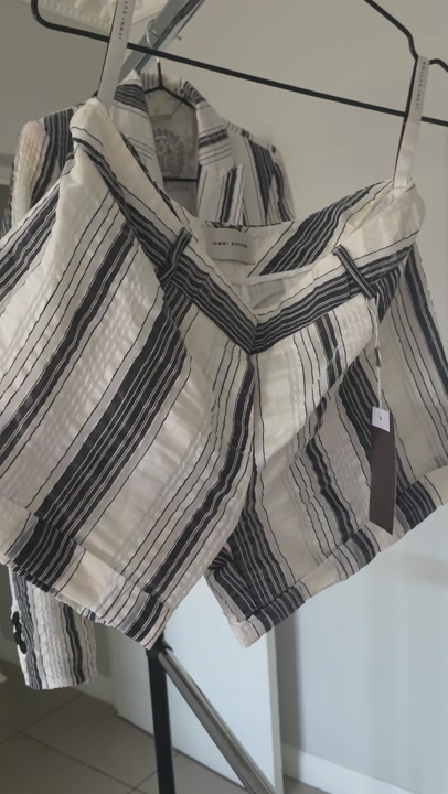 A sleek striped Grey and white short and blazer suit by Jenni Button 